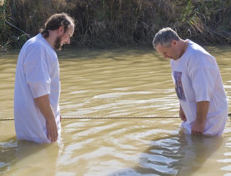 QASER EL YAHUD , ISRAEL - JAN 18 : Unidentified pilgrim men participates in the baptising ritual during the epiphany at Qaser el yahud , Israel in January 18 2012