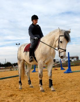training in dressage for a white horse and her riding girl