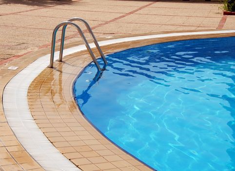 clean cyan swimming pool in summer resort
