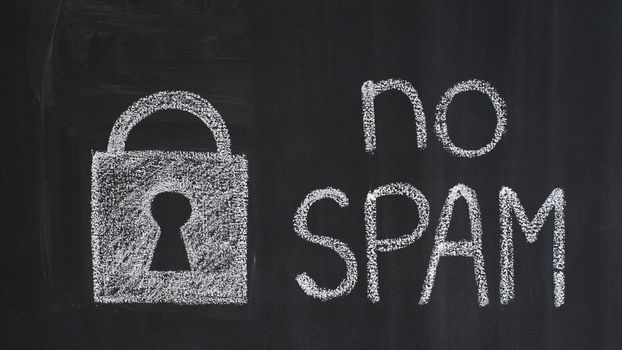 Text "no spam" and padlock drawn on a blackboard