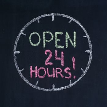 The dial with text "Open 24 hours!", drawn on a blackboard