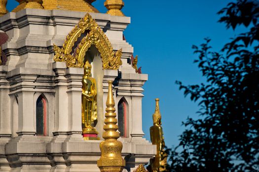 Golden statue of Buddha in buddhist chedi