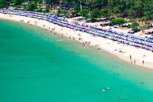 Crowd of tourists on the sandy beach of Phuket island, Thailand