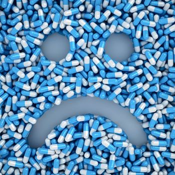 Sad smile made from many blue pills, sickness concept