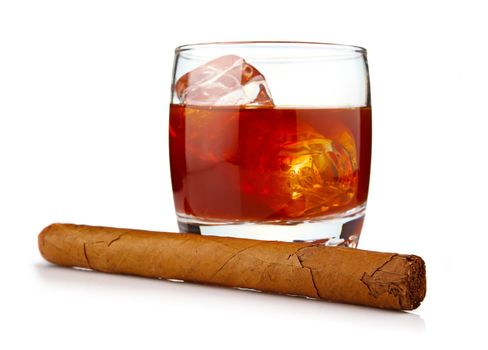 Glass of whiskey with ice cubes and havana cigar isolated on white background 