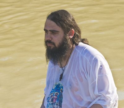 QASER EL YAHUD , ISRAEL - JAN 18 : Unidentified pilgrim man participates in the baptising ritual during the epiphany at Qaser el yahud , Israel in January 18 2012