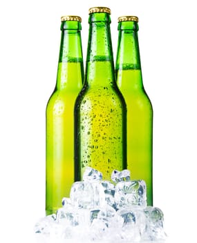 Three green bottles of beer with ice isolated on white background