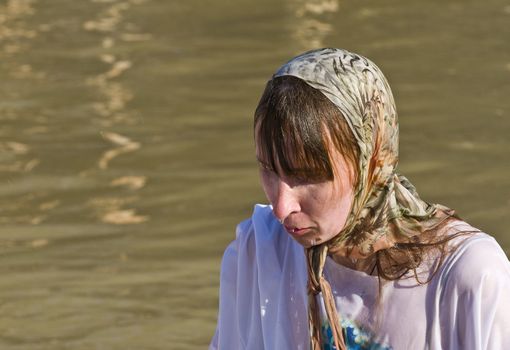 QASER EL YAHUD , ISRAEL - JAN 18 : Unidentified pilgrim woman participates in the baptising ritual during the epiphany at Qaser el yahud , Israel in January 18 2012