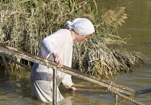 QASER EL YAHUD , ISRAEL - JAN 18 : Unidentified pilgrim woman participates in the baptising ritual during the epiphany at Qaser el yahud , Israel in January 18 2012