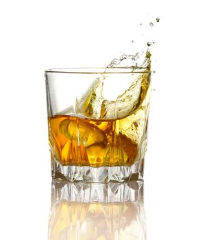 Splash in glass of whiskey and ice isolated on white background 