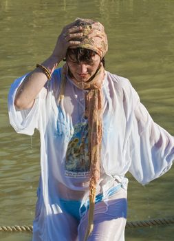 QASER EL YAHUD , ISRAEL - JAN 18 : Unidentified pilgrim woman participates in the baptising ritual during the epiphany at Qaser el yahud , Israel in January 18 2012