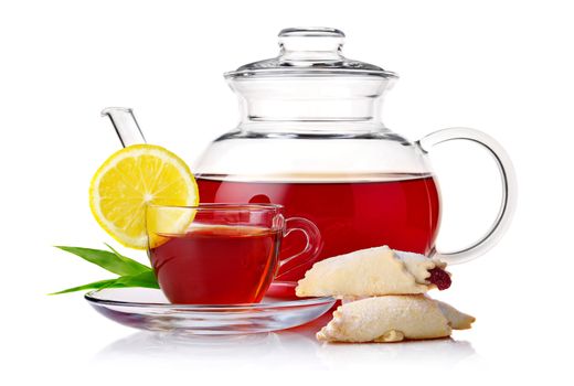 Teapot and cup of black tea with crescent and lemon slice isolated on white background