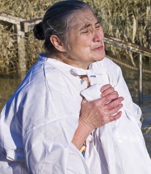 QASER EL YAHUD , ISRAEL - JAN 18 : Unidentified pilgrim woman participates in the baptising ritual during the epiphany at Qaser el yahud , Israel in January 18 2012