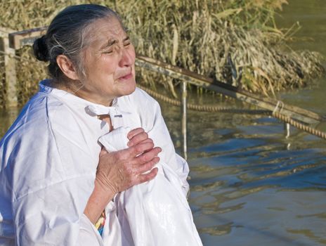 QASER EL YAHUD , ISRAEL - JAN 18 : Unidentified pilgrim woman participates in the baptising ritual during the epiphany at Qaser el yahud , Israel in January 18 2012