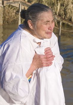 QASER EL YAHUD , ISRAEL - JAN 18 : Unidentified pilgrim woman participates in the baptising ritual during the epiphany at Qaser el yahud , Israel in January 18 2012