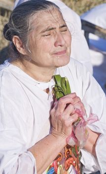 QASER EL YAHUD , ISRAEL - JAN 18 : Unidentified pilgrim woman participates in the baptising ritual during the epiphany at Qaser el yahud , Israel in January 18 2012