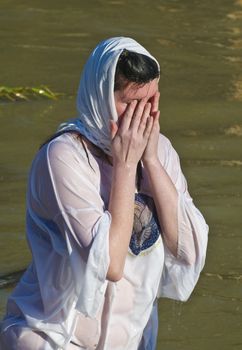 QASER EL YAHUD , ISRAEL - JAN 18 : Unidentified pilgrim woman participates in the baptising ritual during the epiphany at Qaser el yahud , Israel in January 18 2012