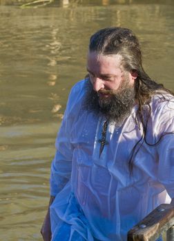 QASER EL YAHUD , ISRAEL - JAN 18 : Unidentified pilgrim man participates in the baptising ritual during the epiphany at Qaser el yahud , Israel in January 18 2012