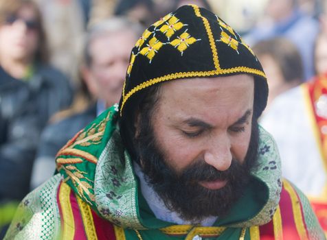 QASER EL YAHUD , ISRAEL - JAN 19 : Syrian Orthodox priest participates in the annual baptising ceremony during the epiphany at Qaser el yahud , Israel in January 19 2012