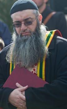 QASER EL YAHUD , ISRAEL - JAN 19 : Syrian Orthodox priest participates in the annual baptising ceremony during the epiphany at Qaser el yahud , Israel in January 19 2012