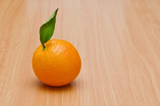 Natural looking orange on the wooden table, Horizontal shot
