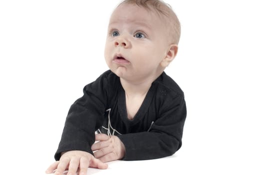 Shot of little baby lying on white background