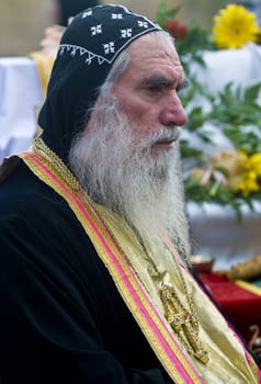 QASER EL YAHUD , ISRAEL - JAN 19 : Syrian Orthodox priest participates in the annual baptising ceremony during the epiphany at Qaser el yahud , Israel in January 19 2012