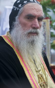 QASER EL YAHUD , ISRAEL - JAN 19 : Syrian Orthodox priest participates in the annual baptising ceremony during the epiphany at Qaser el yahud , Israel in January 19 2012