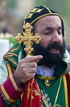 QASER EL YAHUD , ISRAEL - JAN 19 : Syrian Orthodox priest participates in the annual baptising ceremony during the epiphany at Qaser el yahud , Israel in January 19 2012