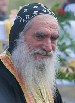 QASER EL YAHUD , ISRAEL - JAN 19 : Syrian Orthodox priest participates in the annual baptising ceremony during the epiphany at Qaser el yahud , Israel in January 19 2012