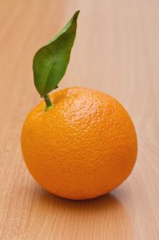 Natural looking orange on the wooden table, Vertical shot 