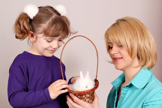 daughter and mother with dwarf white bunny pet 