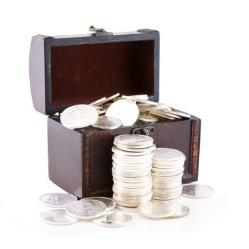Old wooden case full of silver coins, isolated on white
