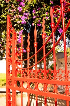 Red iron fence located in the  house front
