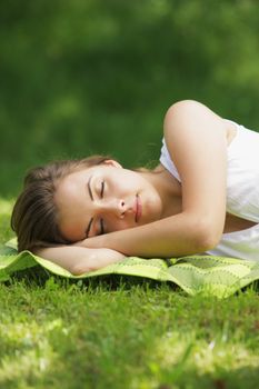 Beautiful woman lying and sleep on the grass