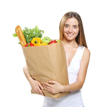 Young woman holding a shopping bag full of groceries, isolated on white background