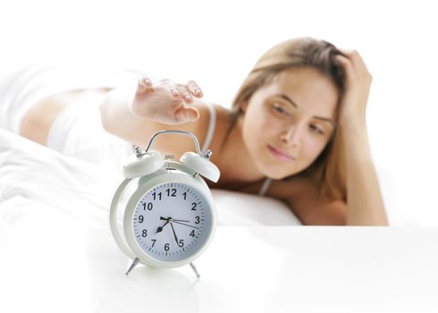 Woman turning off the alarm clock