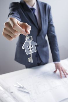 Young businessman giving house keys