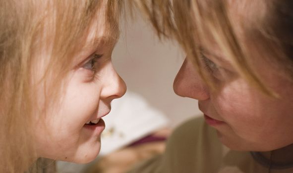 Mother and smiling daughter. Eye to eye