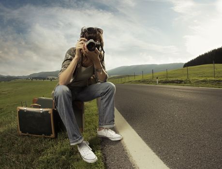 A woman photographer on the side of the road.Copy space