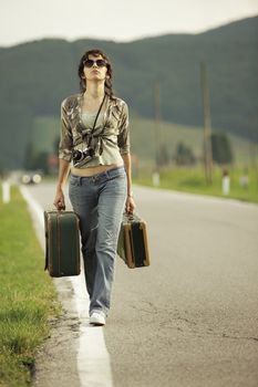 Young woman runaway walks away road