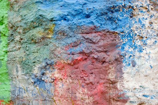 Background of wall painted various colors. Rough surface backdrop.
