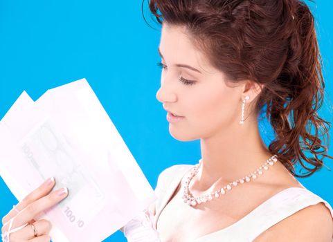 happy bride with money in envelopes over blue