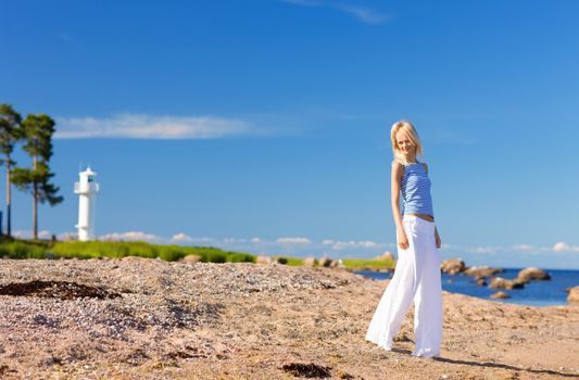 happy woman in striped vest on the seashore