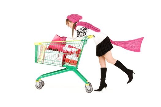 happy teenage girl with shopping cart over white