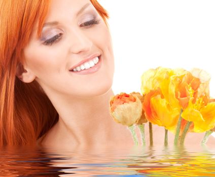 picture of redhead woman with flowers in water