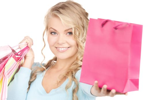 happy woman with shopping bags over white