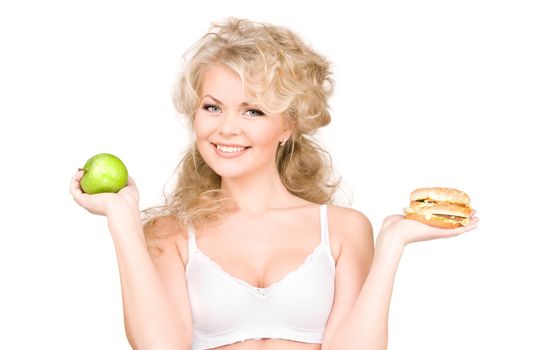 young beautiful woman choosing between burger and apple.