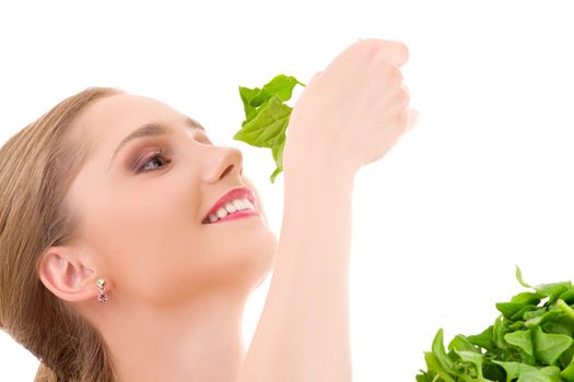 picture of happy woman with spinach over white