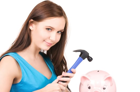 lovely teenage girl with piggy bank and hammer